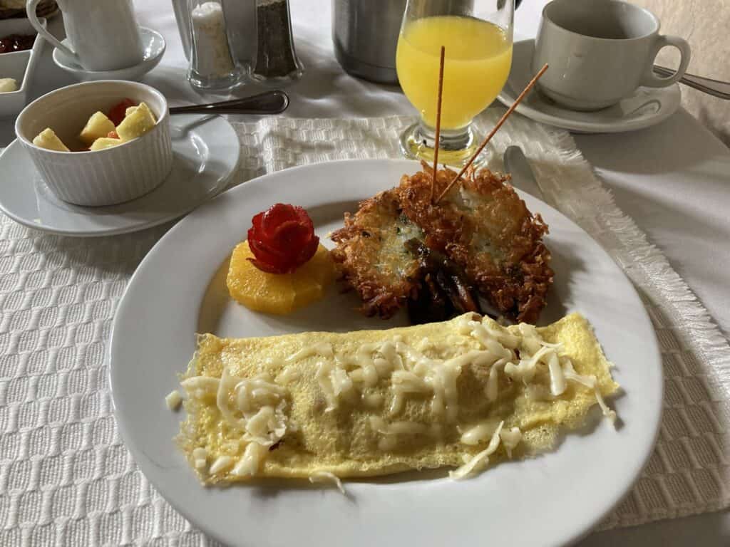 Breakfast at San Rafael Hotel in Antigua, Guatemala. Omelet, hashbrown, fruit, and orange juice