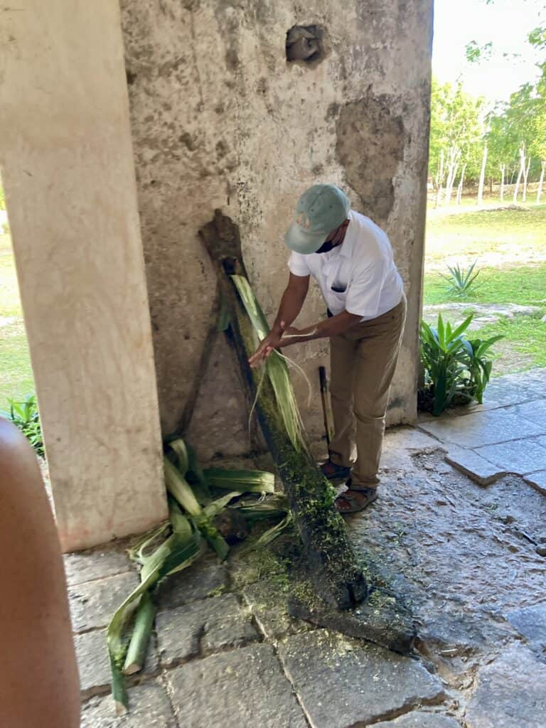 A man demonstrates making rope from henequin at Hacienda Mucuyche