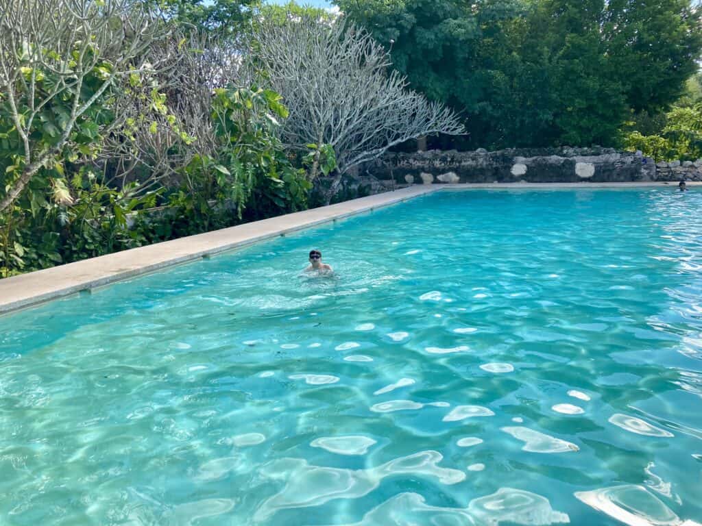 A boy swims in the pool at Hacienda Mucuyche