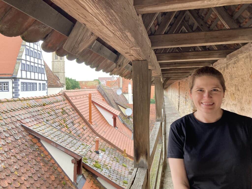 Woman standing on medieval wall in Rothenburg ob der Tauber, Germany