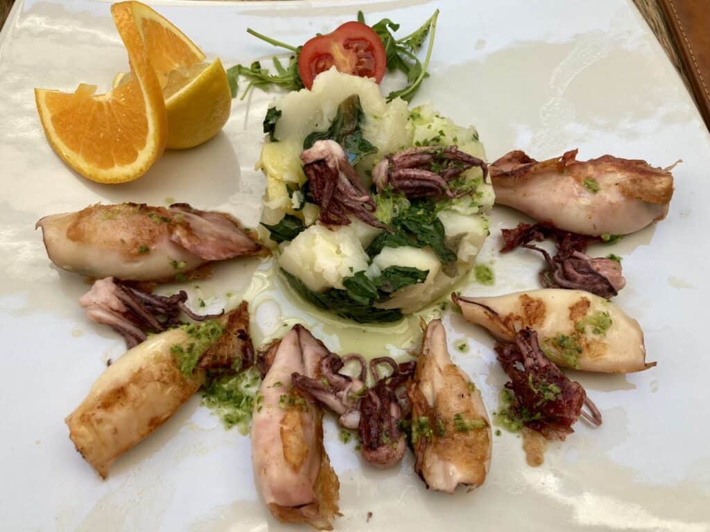 Squid with potatoes and an orange in Kotor, Montenegro