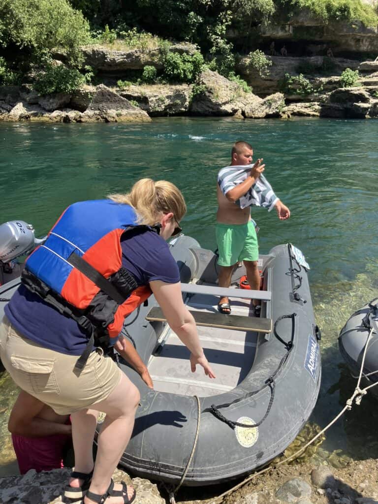 A woman getting into a raft on the Neretva River in Mostar, Bosnia and Herzegovina