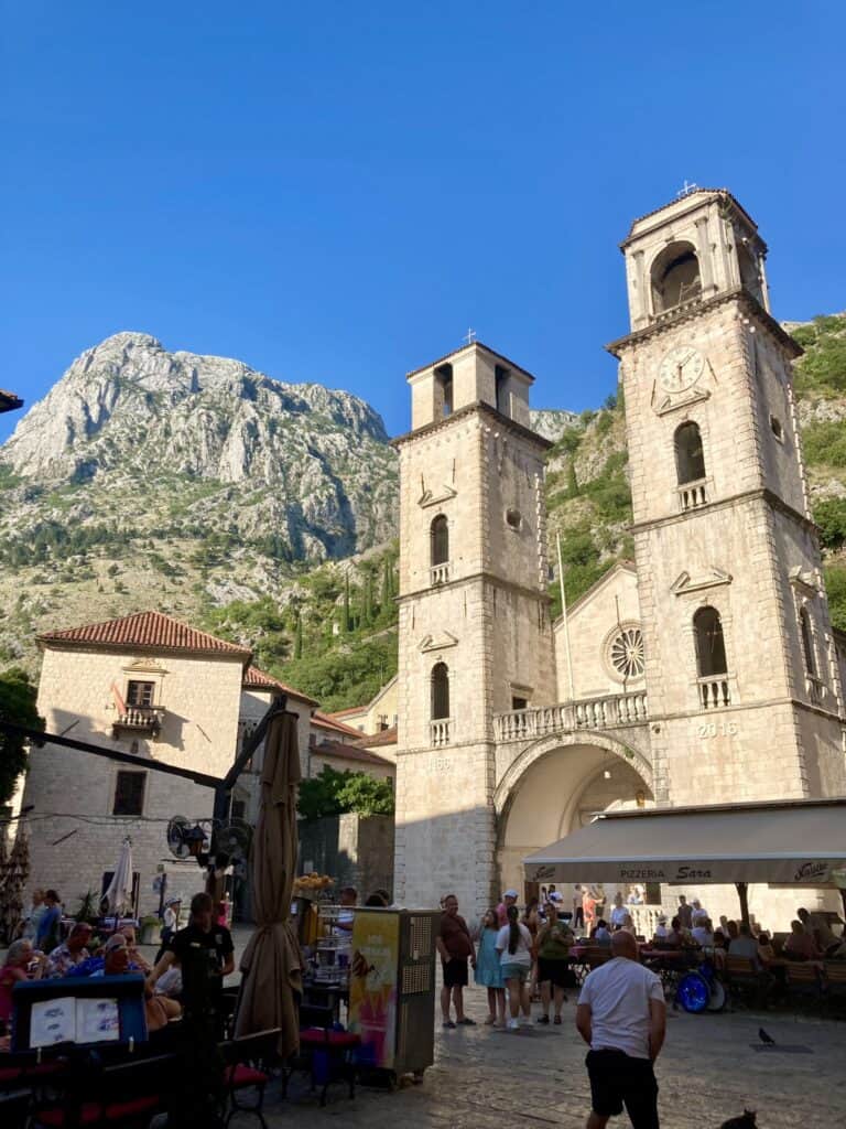 Cathedral with mountain behind it in Kotor, Monetengro