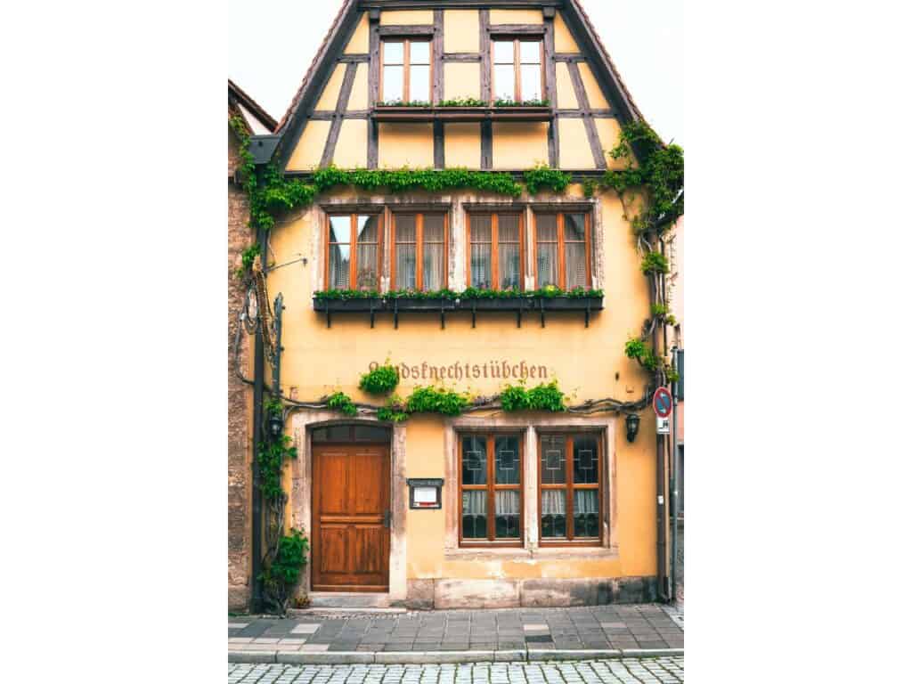 Yellow building with vines on the front in Rothenburg ob der Tauber, Germany