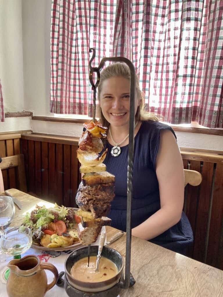 woman with meat and vegetable skewer