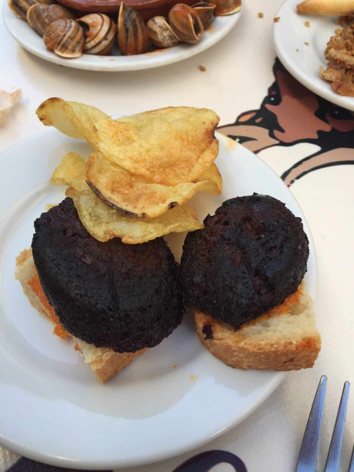 Blood pudding with potato chips in Ronda, Spain