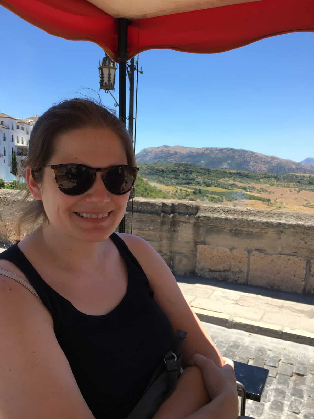 Woman on a cart with mountains in the background