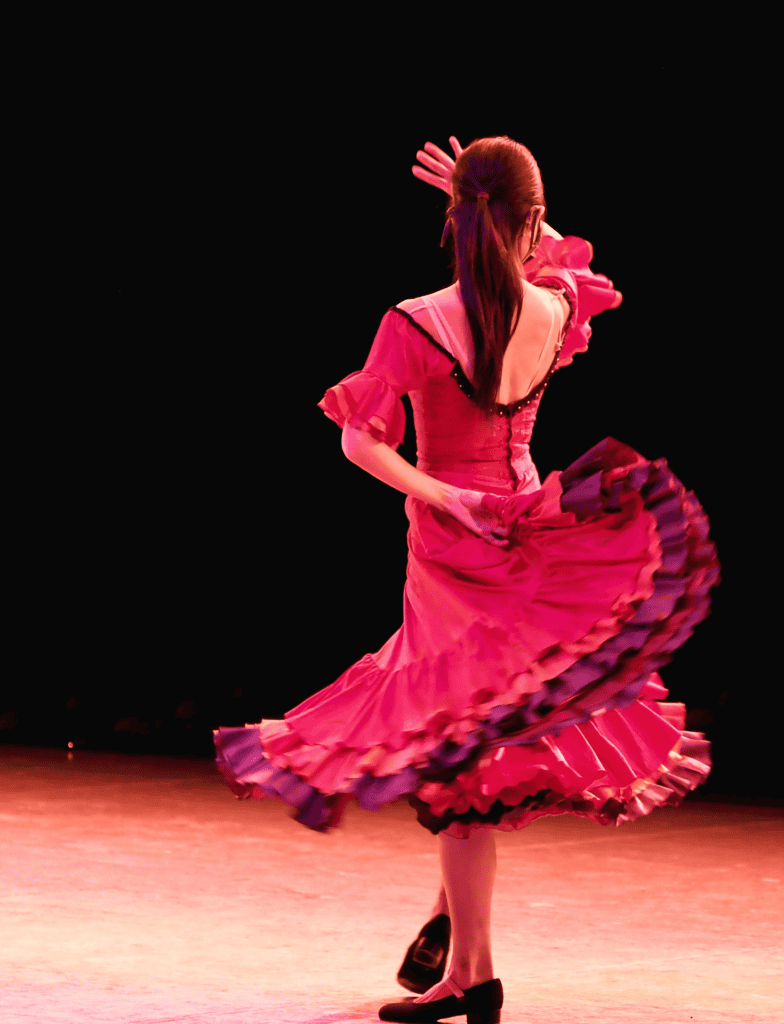 Flamenco dancer mid-dance wearing a red dress