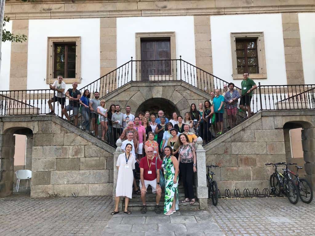 Large group of people standing on steps posing for the camera in Barco de Avila, Spain