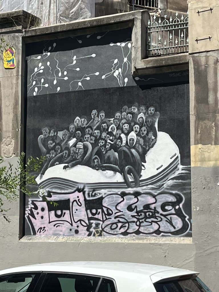 Street art of migrants in a boat